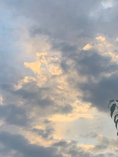 there is a kite flying high in the sky with clouds behind it on a cloudy day