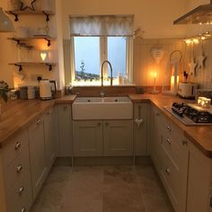 a kitchen filled with lots of counter top space next to a stove top oven and sink