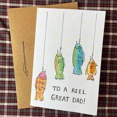 a father's day card featuring three fish hanging from strings with the words to a reel great dad