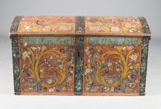 an ornately decorated box with floral designs on it's sides and two doors