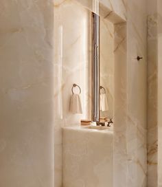 a bathroom with marble walls and flooring