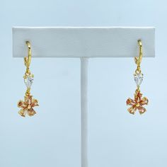 18k Gold Filled Cubic Zirconia White and Amber Color Flower Shape Design Drop Dangle Earrings Wholesale Jewelry. -Earrings Size: Flower Width: 10mm | Drop Length: 20mm | Height: 33mm Gold Cubic Zirconia Dangle Flower Earrings, Gold Dangle Flower Earrings With Cubic Zirconia, Color Flower, Drop Dangle Earrings, Amber Color, Flower Shape, Shape Design, Wholesale Jewelry, Flower Design