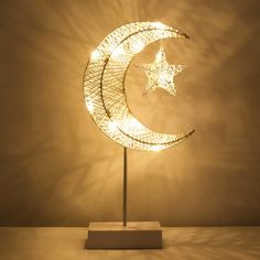 a light that is sitting on top of a wooden stand in the shape of a crescent and star