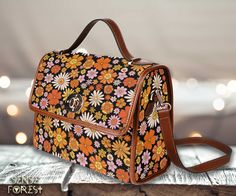 "Retro 70s Hippies Daisy floral Canvas Satchel bag, Cute women boho crossed body purse, cute vegan leather strap hand bag, hippies boho gift .:18.94 Oz. Made from high-grade waterproof canvas, durable, water-resistant. .:Two interior pockets for small items one zipper pocket. .:Removable and adjustable brown Vegan leather shoulder strap. .:Vegan leather trim. .:Dimensions: 10.63\"(L) x 4.13\"(W) x 7.87\"(H) ❣️Actual colours may vary. This is due to computer monitors displaying colours differentl Vintage Shoulder Bag With Adjustable Strap For Spring, Retro Crossbody Shoulder Bag For Spring, Retro Shoulder Bag With Adjustable Strap For Spring, Vintage Orange Bag As Gift, Vintage Orange Bag For Gift, Vintage Brown Bags For Spring, Vintage Floral Print Shoulder Bag For Spring, Spring Vintage Floral Print Shoulder Bag, Vintage Brown Shoulder Bag With Floral Print