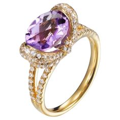 Bursting with vibrant violet hues, this beautiful ring is sure to attract admiring glances. Featuring an oval cut Amethyst, weighing 1.37 carat, surrounded by 2.28 carat of round brilliant cut cubic zirconia, sitting beautifully in a split shank, composed of 925 sterling silver with either a 14 karat yellow gold or a high gloss white rhodium finish. Whether you're looking for a classic piece to add to your jewelry box, or something totally on-trend, designers Lustre of London believe that every