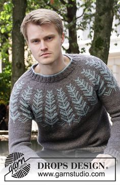 a man wearing a sweater with leaves on it