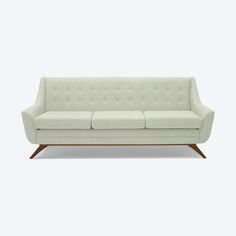 a white couch sitting on top of a wooden frame