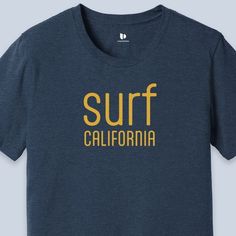 Surf California T-Shirt available in Navy Blue Heather color  This classic unisex jersey short sleeve tee fits like a well-loved favorite. Soft cotton and quality print make users fall in love with it over and over again. These t-shirts have-ribbed knit collars to bolster shaping. The shoulders are tapered for a better fit over time. Dual side seams hold the garment's shape for longer.  .: This t-shirt comes with a lightweight fabric (4.2 oz/yd² (142 g/m that is easy to layer thanks to its breathability and the perfect choice for both active and leisure wear. The 100% Airlume combed and ring-spun cotton feels soft to the touch. .: The retail fit that is perfect for casual and semi-formal settings. Meanwhile, the crew neckline adds a timeless, classic touch and a neat appearance that is per Relaxed Fit Short Sleeve Surfing Shirt, Cotton Short Sleeve Surfing T-shirt, Short Sleeve Cotton T-shirt For Surfing, Relaxed Fit Crew Neck Surfing T-shirt, Cotton Short Sleeve T-shirt For Surfing, Relaxed Fit Crew Neck T-shirt For Surfing, Surfing Crew Neck T-shirt With Letter Print, Short Sleeve Screen Print Tops For Surfing, Cotton Surfing Shirt With Letter Print