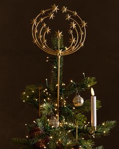 a christmas tree with candles and ornaments on it