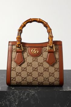 Gucci's 'Diana' bag is part of the 'Love Parade' collection, which revives Old-Hollywood glamor. Crafted in Italy, it's made from canvas-jacquard that's detailed with crystal-dusted 'GG' motifs and trimmed with leather. The bamboo top handles have been a brand signature since the '40s. Attach the shoulder strap to go hands-free. Hand Bag Gucci, Luxury Purses Gucci Bags, Gucci Bamboo Bag, Gucci Bags Handbags, Gucci Diana, Gucci Products, Hollywood Glamor, Multi Colored Bag, Shoe Storage Solutions