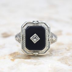 Antique 14k white gold Art Deco era flip ring. One side has a carved shell cameo. The other, an onyx stone set with a small diamond. The filigree setting has blossom details on the shoulders and along the band.  Era: Art Deco c.1920 Markings: 14k PATENTED  Materials: 14k white gold, shell, onyx, diamond  Ring Size: 6.5 (Comes with one free resizing by our jeweler) Weight: 3.1 grams Face measures 14mm x 12mm Condition: Excellent antique condition with minor wear from age  Shipping is free in the United States  Follow us on Instagram @LUXXORVintage Oval White Gold Jewelry With Black Enamel, Victorian Black Enamel Wedding Rings, Victorian Black Enamel Rings For Anniversary, Victorian Black Enamel Anniversary Rings, Victorian White Gold Signet Ring For Formal Occasions, Polished Onyx Jewelry For Wedding, Wedding Onyx Jewelry With Polished Finish, Antique Jewelry With Polished Finish For Evening, Evening Antique Jewelry With Polished Finish