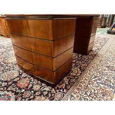 two wooden desks sitting on top of a rug in a room with carpeting