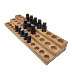 a wooden tray with bottles on it and an empty bottle holder in the bottom row