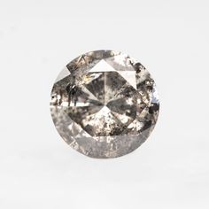 an oval cut diamond on a white background with the center stone in grey and black