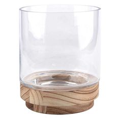 a clear glass with wooden base on a white background