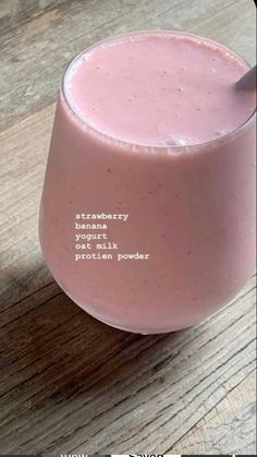 a pink smoothie in a glass with a spoon on the side that says strawberry yogurt protein powder