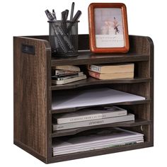 a wooden shelf with books and papers on it, next to a framed picture frame