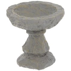 a stone pedestal with two small rocks on top