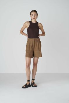 Want to look elegant and show a bit of leg? Discover the Bièl shorts in Cappuccino Brown. These shorts feature a high and slim fit at the waist, with a relaxed fit in the leg. They include a double pleat and two side pockets. The Bièl shorts are perfect for the warmer summer days, but also look stunning in the winter when paired with tights and boots. Complete your look with the matching June Jacket.The fabric is a mix of organic and recycled cotton. The yarns are traditionally plant dyed with b Brown Shorts For Workwear, Brown Workwear Shorts, Classic Brown Shorts, Classic Brown Short-length Bottoms, Fitted Brown Bottoms With Short Inseam, Brown Workwear Bottoms With Built-in Shorts, Brown Bottoms With Built-in Shorts For Work, Brown Summer Workwear Shorts, Brown Shorts For Summer Workwear