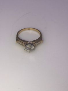 14k yellow gold Diamond Engagement Ring. Center Diamond is .98 ct. I1 clarity, I color, Baguettes total weight .15ct. Size 6 1/4, Circa 2000-2009 Heirloom Yellow Gold Wedding Ring With Center Stone, Timeless 14k Gold Diamond Ring Vs Clarity, 14k Gold Princess Cut Wedding Ring, Elegant Gold Diamond Ring For Proposal, Heirloom Diamond Ring Stamped 14k, Timeless Yellow Gold Wedding Ring With Diamond Accents, Classic Vvs Clarity Baguette Cut Diamond Ring, Yellow Gold Moissanite Wedding Ring With Diamond Accents, Diamond Ring With Brilliant And Baguette Cut For Proposal