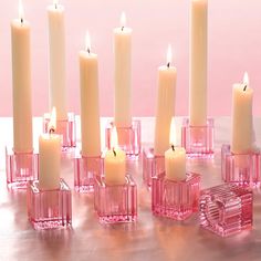 a group of pink candles sitting next to each other