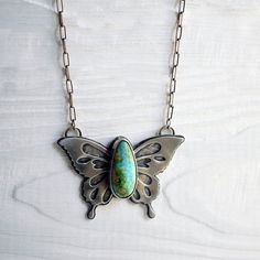 Beautifully handcrafted sterling silver butterfly pendant with a large, breathtaking high-grade Sonoran Gold turquoise stone.This heirloom quality piece is quite substantial & has some weight to it - with its layers & layers of sterling silver. This special piece has been intricately hand sawed, with pierce work throughout the butterfly's wings. Underneath the pierce work, is a textured layer of silver.The reverse side of the butterfly has a hand stamped message that says, "embrace change" ... a Bohemian Sterling Silver Butterfly Necklace, Bohemian Butterfly Sterling Silver Necklace, Turquoise Butterfly Sterling Silver Jewelry, Handmade Turquoise Butterfly Jewelry, Unique Sterling Silver Jewelry With Butterfly Charm, Metal Smithing, Embrace Change, Silver Butterfly, Butterfly Pendant