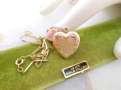 Heart photo charm locket. All about...Mom. Pendant necklace. Gold filled locket and chain. Designer - 1/20 14k GF - maker mark TK or KT Locket petite 5/8" diameter. Frames still intact.  Chain 18" Spring C clasp. Lovely vintage condition. MORE Krementz and gold filled here: https://www.etsy.com/shop/VivianJoel?ref=seller-platform-mcnav&section_id=28421111 MORE everything VivianJoel here: https://www.etsy.com/shop/vivianjoel Desired cleaning is left to new owner.   Still uncertain about size?   C Collectible Gold Jewelry With Heart Charm, Gold Heart Pendant Locket Necklace Collectible, Gold Heart Pendant Locket Necklace With Hallmark, Gold Hallmarked Locket Necklace For Valentine's Day, Gold Jewelry With Vintage Charm For Valentine's Day, Gold Locket Necklace, Gift For Mom, Gold Locket Necklace Gift For Mom, Gold Locket Necklace With Hallmark For Mother's Day, Gold Locket Necklace For Mom