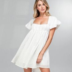 Posh Society's New Women's White Puffy Sleeve Backless Cotton Mini Dress Look hot in this summer-ready white mini dress! Crafted from ultra-soft and comfy cotton, this dress is the perfect mix of cute and sassy with its puff sleeves and backless style. Add some sizzle to your wardrobe with this puffy-sleeve stunner! 100% Cotton Square Neckline Short Puffy Sleeve Self Tie Back Straps Backless Solid White Print Super Soft & Comfy Fits True To Size In Stock White Babydoll Dress, Dress With Puffy Sleeves, Cotton Mini Dress, White Dress Summer, Puffy Sleeves, Little White Dresses, Summer Ready, Country Chic, Babydoll Dress