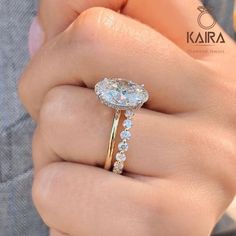 a woman's hand holding an engagement ring