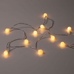 a string of white lights on a gray background