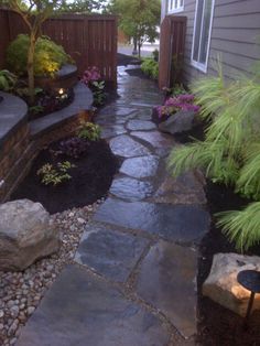 a stone path in the middle of a yard