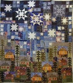 a quilted wall hanging with snowflakes and houses in the woods on it