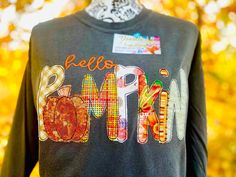 Hello Pumpkin Custom Embroidered Shirt. Great for Fall, Or Thanksgiving. This is done as vintage, raw edge  Embroidered Appliqué Fall multi colored fabrics however you can choose the color you want & a fabric color theme in single or multiple.  If you like the sample you can choose it as well.This is available in Long sleeve T, Sweatshirt, or a raglan shirt.   This is also available on reg Gildan styles or Comfort Colors, Hanes Comfort Wash.  Each shirt is unique as fabrics may vary depending on availability. Shirts run true to size of a unisex.  This can be done in your choice of theme colors.  The raw edge will allow the fabrics to fray a little with each wash giving it a vintage look. Please allow 2 weeks to complete.  If you need sooner please msg. Custom made so no refunds Raw Edge Applique, Hello Pumpkin, Santa Shirts, Raglan Shirt, Pumpkin Shirt, Raglan Shirts, Color Theme, Fall Shirt, Pride Shirts