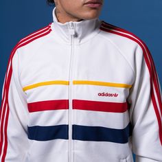 Take your style back in time with the retro-looking adidas Sport Leaf First Men's Track Jacket. While the colors give it that throwback look, the soft material will keep you comfortable, even when you have a long day ahead of you. And this jacket has a relaxed fit, allowing you to layer it with a tee or sleeveless or lightweight, long-sleeved shirt.Easy to layer. Fitted hem and cuffs. Features side pockets. Long-sleeved. Zip-up. Machine washable. Adidas Three Stripes Outerwear For Sports Events, Adidas Outerwear With Three Stripes For Sports Events, Retro White Outerwear With Ribbed Cuffs, White Track Jacket For Fall Sports Events, Adidas Cotton Track Jacket In Casual Style, Winter Sports Outerwear With Three Stripes, White Adidas Winter Outerwear, Adidas Cotton Sporty Track Jacket, White Adidas Logo Long Sleeve Outerwear