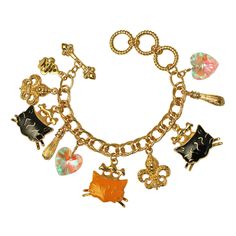 Ritzy Couture Princess Kitty Black & Tabby Multi Charm Toggle Bracelet (Goldtone). We both know your cat is queen of the house. Now you can be ruler of your accessories game with this feline friendly necklace! This bracelet boasts a collection of drop charms including two Fleur-de-Lis, an iridescent heart-shaped charm and several pretty kitties wearing cute princess crowns decorated with clear glass stones. The easy to use toggle makes taking off this bracelet a breeze -- which means more cat time for you! Bracelet adjusts from 7.0", 7.75" to 8.5". Goldtone Double Curb Chain. Charms are detailed front and back. Adjustable. Toggle Bracelet. Measures approximately 7.0" to 8.5" Ritzy Couture by Esme Hecht – Original Designer of Lunch at The Ritz Designed with love in the USA Imported Princess Crowns, Princess Kitty, Cat Bracelet, Couture Accessories, Cute Princess, Cat Charm, Toggle Bracelet, Lucky Clover, Couture Jewelry