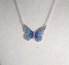 Pretty enamel and imitation rhodium-plated, 35x25mm single-sided butterfly - shown here in blue and green with glitter (6 color choices - see photos). Necklace is made with silver filled rolo chain with a lobster clasp - select length during checkout. Comes in a gift box. Photos - 1, 2, & 3 = Blue and Purple Photo 4 - Black Photo 5 - Green Photo 6 - Orange Photo 7 - Pink Photo 8 - Purple ليلو وستيتش, Orange Photo, Purple Photo, Butterfly Necklace Silver, Pretty Jewelry Necklaces, Black Photo, Pink Photo, Green Photo, Magical Jewelry