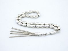 It is made of 100% silver, including the chain. General: 33 pcs 6x9 mm bead size  Weight: 25.2  grams Length: 21 cm including tassel Material:  925 sterling silver. See our other models here: http://www.etsy.com/shop/Tesbih?ref=si_shop   Hand-made. Do not compare it to products sold in the shops. Each one makes the master. Tried using the most robust rope. Disperse a day in two days. Remain intact for many years. Does not Tarnish metals were used. The unique design is unique. Elegant Sterling Silver Rosary In Silver, Elegant Silver Sterling Silver Rosary, Elegant Silver Beads Rosary Gift, Handmade Silver Traditional Rosary, Handmade Traditional Silver Rosary, Traditional Silver Rosary With Polished Beads, Traditional Handmade Silver Rosary, Traditional Silver Rosary As Gift, Islamic Prayer