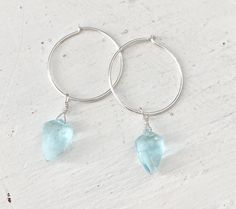 Dainty little aquamarine faceted crystal gemstone hoop earrings in 20mm sterling silver or 14k gold filled hoops. Option for gold plated and silver plated are less expensive. Please see drop down. Perfect for March birthdays! 💙Aquamarine, a stone of serenity, calms and soothes with it's lovely blue/green color and evokes the calm of the water with it's given name, which is interpreted at 'water of the sea' derived from Latin. A stone that celebrates the sea goddess of ancient times, it was carr