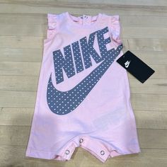 Nike Baby Girl Onesie Outfit. Brand New With Tag - Never Worn. 6m Size. Light Pink With Gray Print. Pink Onesie With Letter Print For First Birthday, Cute Pink Onesie With Letter Print, Playful Pink Onesie With Letter Print, Pink Onesie For Summer, Pink Cotton Onesie For Playwear, Pink Cotton Onesie For Spring, Pink Letter Print Onesie For Summer, Summer Pink Onesie With Letter Print, Pink Cotton Onesie With Letter Print