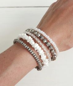 Beaded layered statement cuff bracelet white and gray beads and stones. White Stacked Bohemian Beaded Bracelets, White Multi-strand Beaded Bracelets, Adjustable Stacked White Beaded Bracelets, Adjustable White Stacked Beaded Bracelets, White Multi-strand Beaded Bracelets With Spacer Beads, White Round Beads Bracelets For Layering, Adjustable White Beaded Bracelets For Layering, Statement Cuff Bracelet, Beaded Cuff Bracelet