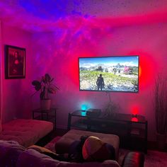 a living room filled with furniture and a large flat screen tv mounted to the wall