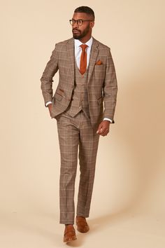 In a subtle light tan with a classic Prince of Wales check, the Ray suit is sophisticated and timeless in its design. Featuring a gold and blue colour pop MD lining and with complimenting brown buttons and velvet trim to the pockets, this three-piece is sure to make an impact at any formal event. The perfect suit for stylish office wear or for attending a wedding. Models wears size 38R blazer, 38R waistcoat & 32R trousers. Features Prince of Wales Check Slim fit Single-breasted Notch lapel Singl Tailored Brown Three-piece Suit For Formal Occasions, Brown Tailored Three-piece Suit For Formal Occasions, Tailored Brown Three-piece Formal Suit, Formal Brown Three-piece Suit With Welt Pockets, Brown Tailored Sets With Suit Collar, Brown Single Breasted Suit Sets, Brown Single Breasted Business Sets, Brown Single-breasted Suit Sets, Elegant Brown Three-piece Suit With Single Button