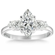 a white gold ring with a pear shaped diamond in the center and leaves on each side