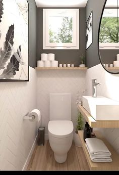 a white toilet sitting under a bathroom mirror next to a wooden shelf filled with towels