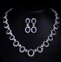 Channel timeless elegance with this Princess Diana-inspired Sapphire Necklace and Ring Set, part of our exquisite India Diamond Jewelry collection. The deep blue allure of the sapphire necklace perfectly complements the brilliance of American Diamonds in this bridal wedding set. Embrace sophistication and regal charm with this captivating ensemble. *𝐏𝐑𝐎𝐃𝐔𝐂𝐓 𝐃𝐄𝐓𝐀𝐈𝐋* * Material: Brass * Plating: White Rhodium Plated * Stone: AAA Quality CZ Diamond & Sapphire. *𝐃𝐈𝐌𝐄𝐍𝐒𝐈𝐎𝐍𝐒* *    Necklace- Weight: 32 gm, Length: 8.7 Inches, Drop Length: 4.5 Inches, Width: 0.7 Inches *    Earrings- Weight: 6 gm Each, Length: 1.65 Inches, Width: 0.65 Inches *𝐒𝐇𝐈𝐏𝐏𝐈𝐍𝐆 𝐏𝐎𝐋𝐈𝐂𝐘* * Shipping: worldwide from India. * Free shipping: All our products have a free standard shipping polic Formal Blue Sapphire Necklace, Oval Blue Diamond Necklaces, Blue Oval Diamond Necklaces, Blue Diamond Jewelry Sets For Wedding, Royal Blue Crystal Jewelry For Party, Elegant Blue Crystal Jewelry Sets, Sapphire Crystal Jewelry For Wedding, Blue Crystal Jewelry Set For Anniversary, Blue Cubic Zirconia Jewelry For Party