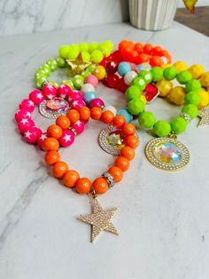 Our bracelets are beautifully crafted and handmade! Using high end beads, charms, & embellishments! They are truly fun and crafted in excellence Unique styles and colors are chosen and put together to create a luxurious and one of a kind experience!~ The styles are versatile and range from chic, girly, edgy, neutral, & western! They don't last long and are always limited edition! Measure: on average 6.75-9.5 with stretch! AllJewelry ~Final Sale~ Warning: Screen Resolutions & Lighting may vary th Playful Jewelry With Round Beads And Charms, Playful Jewelry With Charms And Round Beads, Playful Jewelry With Round Bead Charms, Trendy Colorful Jewelry With Large Beads, Trendy Star-shaped Party Bracelet, Trendy Star Bracelet For Party, Trendy Star-shaped Bracelets For Party, Bohemian Star-shaped Beaded Bracelet, Multicolor Star Charm Jewelry For Party