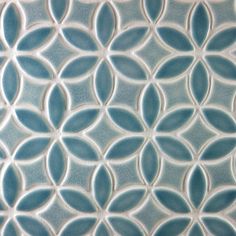 a close up view of a blue tile with circular designs on the bottom and sides