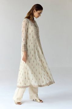 Antique white paneled flared kurta with fabricated floral and thread embroidery highlighted with sequins. Comes with georgette trouser and scarf. - Aza Fashions White Maxi Length Set With Sheer Dupatta, Cotton Silk Floor-length Anarkali Set, Elegant Full-length Anarkali Set With Pallu, Elegant Full Length Anarkali Set With Pallu, Elegant White Mulmul Anarkali Set, Elegant Long Sleeve Mulmul Anarkali Set, Zari Work Anarkali Set Full Length, Floor-length Cotton Silk Kurta For Transitional Season, Full Length Anarkali Set With Zari Work