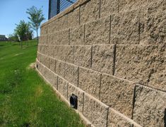 a stone wall that has been built into the grass