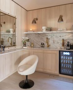 a white chair sitting in a kitchen next to a counter